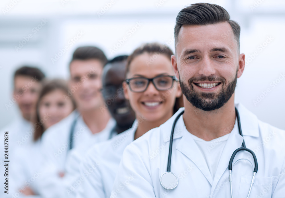 Wall mural team of smiling professional doctors standing together