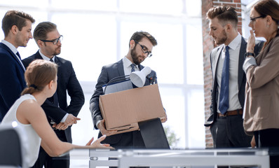 dismissed employee says goodbye to colleagues in the office