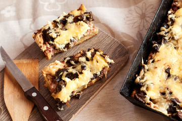 Casserole in pan of potatoes, mushrooms, cheese, simple rustic food, recipe of Slavic, European cuisine.