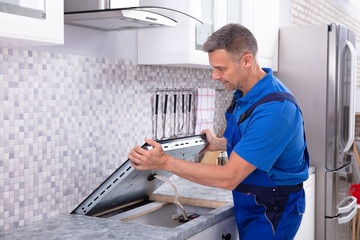 Repairman Installing Induction Stove