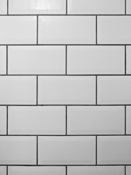 White metro tiles with grey grout. White rectangle tiled background