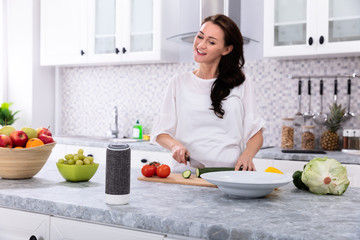 Woman Slicing Cucumber With Kitchen Knife