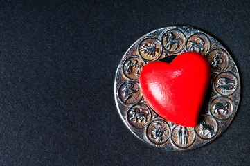 red heart lying on zodiac wheel like astrology and love concept 