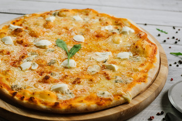 Pizza Formaggio with mozzarella, emental cheese, and cheese philadelphia on wooden background