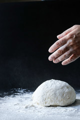 making dough with flour by female hands