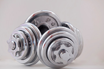 Fitness exercise equipment dumbbell weights on white background. 