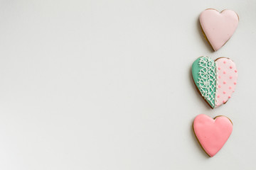Pink colored gingerbread and honey cakes cookies . In the shape of a heart. On a light wooden background. Frame. Place for text. The concept of love, mother's day, cooking, St. Valentine.