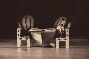 baby playing with miniature dinner set