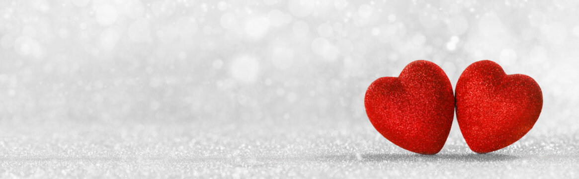 Red hearts on glitter background