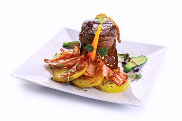 fillet mignon from young bull on herb meat with roasted potato and bacon