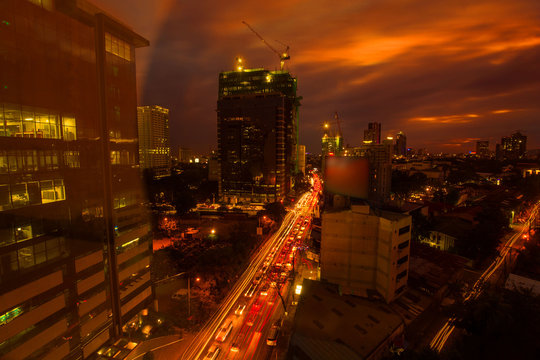 Cebu City urban night photography with car light trails	in a sunset dusk