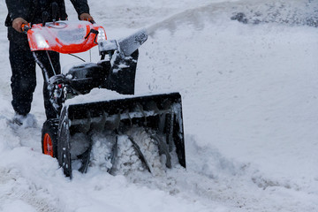 The person deletes snow after snowfall in winter day