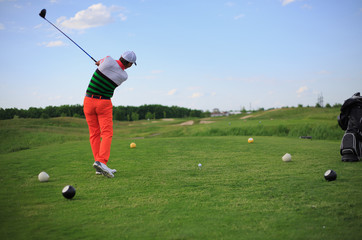 man playing golf on a green field. Professional sports