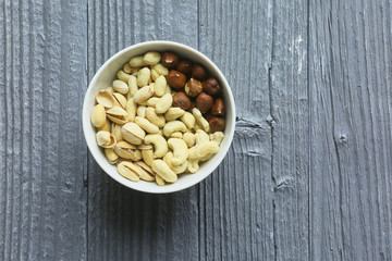 Assortment of nuts on a dark wooden table. View from above