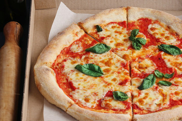 pizza closeup background with tomatoes sauce cheese mozzarella and parmesan and basil leaf. pizza margarita closeup