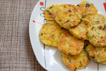Potato pancakes with green onions. Draniki - potato fritters. The naitonal dish of Belarus, Ukraine and Russia. Potato zucchini cakes.