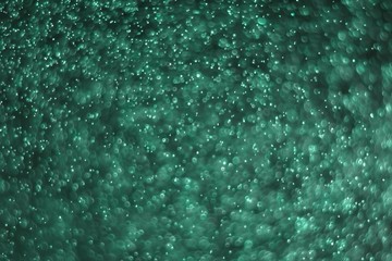 teal, sea-green huge amount flying celebratory glitters bokeh texture - fantastic abstract photo background