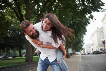 A young funny loving couple have fun on a sunny day.