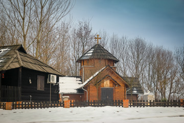 Old idyllic houses in small retro village. Snow melting, sunset, ethno village Moravski Konaci, near the Velika Plana in Serbia.