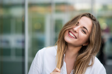 Teenage girl posing while holding her hair