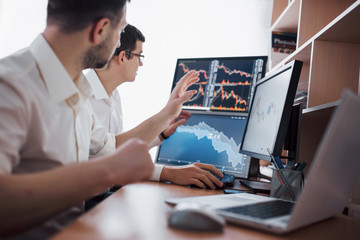 Analyzing data. Close-up of young business team working together in creative office while young...