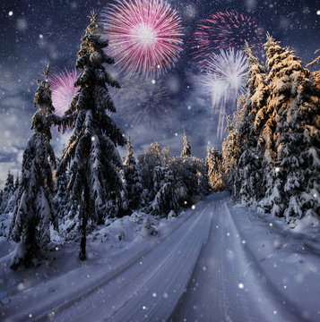 starry sky in winter snowy night. fantastic milky way in the New Year's Eve. Winter road in the mountains. fireworks and holiday lights on the background. Photo greeting card