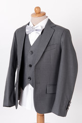 Beautiful men's grey jacket suit with shirt and bow tie on white background
