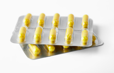 Aluminium blister pack of pills. The capsules are packaged in blisters, isolated on a white background. Disease. Flu. Medications.