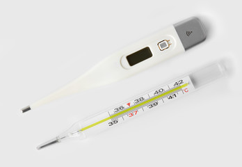 Electronic and mercury thermometer, isolated on white background.