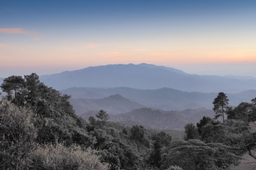 sunset at Huai Nam Dang National Park, beautiful mountain view and pine forest cover with soft mist and colorful yellow light in the sky background, attraction in Chiang Mai, northern of Thailand.