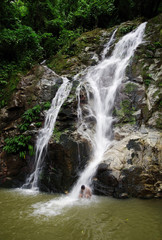 Fototapeta premium Tourists swimming in Marinka Waterfall in Minca, Colombia, Europe