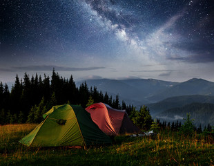 Dairy Star Trek above the tents. Dramatic and picturesque scene at night mountains. Carpathian...
