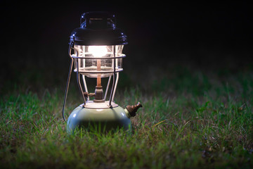 Old lantern On the lawn at night.Vintage colors picture.