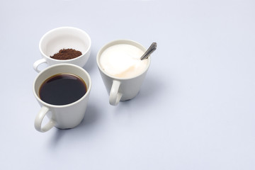 Coffee Cup Assortment Cup of Espresso Cup of Cappuchino Cup with Ground Coffee Blue Background Copy Space