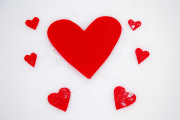 Red hearts on the snow white background