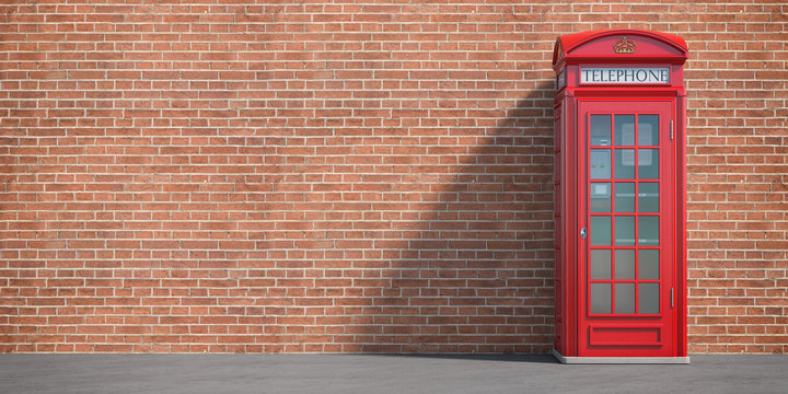Red phone booth on brick wall background. London, british and english symbol. Space for text