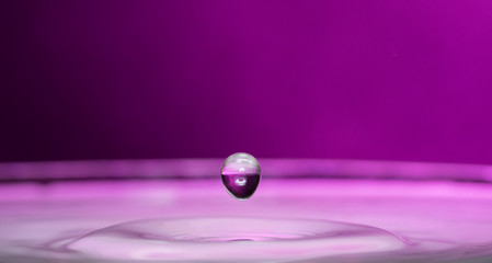Splashed out and splashed from a falling drop on a colored or black background
