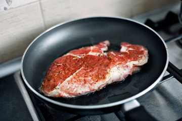 juicy grilled steaks in a frying pan