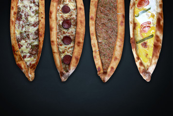 Traditional Turkish pita varieties on black background.