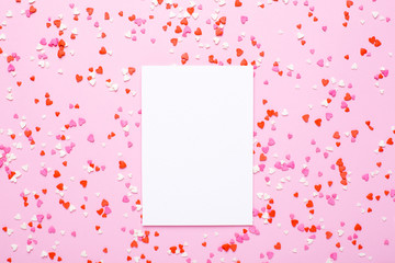 Present card with pink, red hearts on pink background
