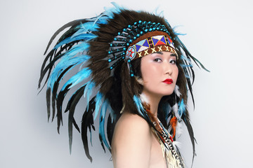 Young beautiful asian woman in vintage costume of American Indian
