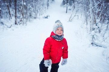 Fototapeta na wymiar cute boy winter walk in forest