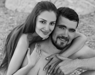 nude couple on the beach hug
