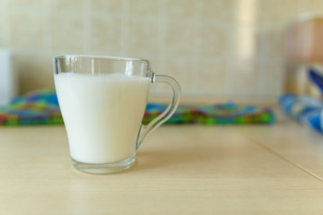 a glass cup of milk on the table in the morning. healthy breakfast concept