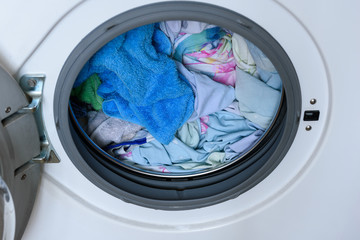 Washer. loaded laundry. filled drum washing machine.