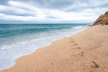 Seashore. Footsteps on the sand