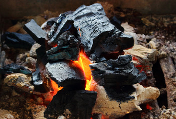 Burning wooden coals on outdoors for grill and bbq. Live red coals