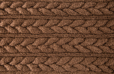 Brown knitted braids fabric textile background. Horizontal lines.
