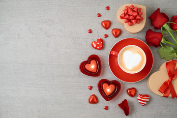 Valentine's day background with coffee cup, heart shape chocolate, candles, rose flowers and gift boxes