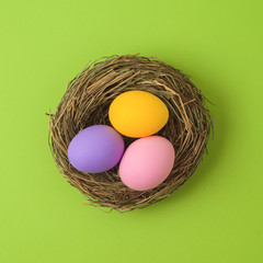 Easter holiday concept with easter eggs in bird nest decorations.